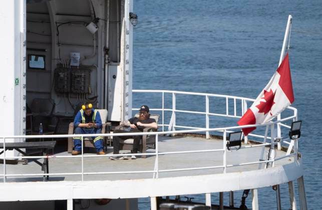 June 24, 2023, St.John s, NL, Canada: Crew of the Polar Prince sit on the back deck of the ship as they wait to be released by Transportation Safety Board investigators after the ship docked in St.JohnöÄÃ s, Nfld. Saturday, June 24, 2023. St.John s Canada  - ZUMAc35_ 20230624_zaf_c35_013 Copyright: xAdrianxWyldx