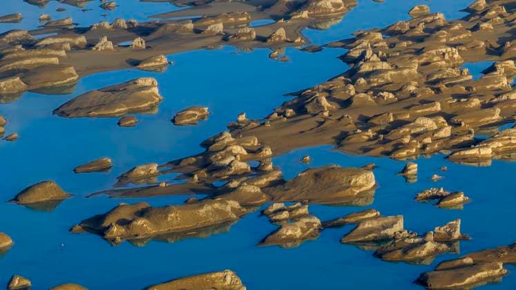 Creative Highlights World HAIXI, CHINA - JUNE 24: Aerial view of yardang rocks in the China Dachadan Wusute Yadan Geological Park after a rainfall on June 24, 2023 in Haixi Mongolian and Tibetan Autonomous Prefecture, Qinghai Province of China. Lying in the Qaidam Basin, the Dachadan Wusute Yadan Geological Park is home to a unique landscape which consists of wind-eroded rocks known as yardangs.  Copyright: xVCGx 111442883157