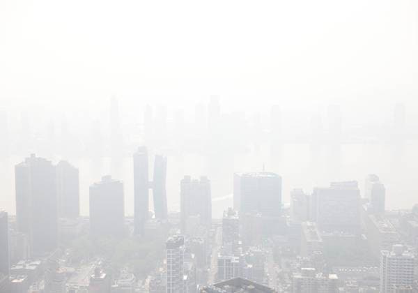 Tourists visit the observation deck of the Empire State Building as haze and smoke due to on going wildfires in Canada shroud the views of the Manhattan skyline on Friday, June 30, 2023 in New York City.  NYP20230630111 JohnxAngelillo