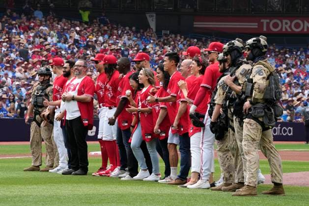 July 1, 2023, TORONTO, ON, Canada: People who took part in a Canada Day citizenship ceremony before the start of MLB AL baseball action between the Toronto Blue Jays and the Boston Red Sox stand with Canadian Armed Forces members in Toronto on Saturday, July 1, 2023. TORONTO Canada  - ZUMAc35_ 20230701_zaf_c35_084 Copyright: xFrankxGunnx