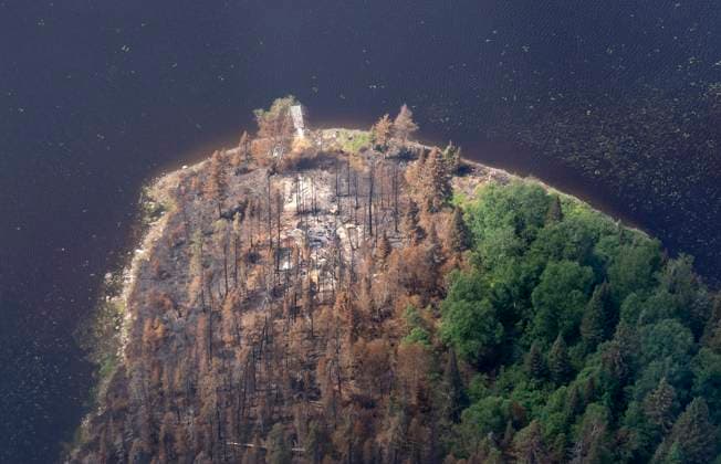 July 5, 2023, Lebel-sur-Quevillon, PQ, Canada: The remains of a cottage are seen in an area affected by fire on a lake south of Lebel-sur-Quevillon, Que., Wednesday, July 5, 2023. Lebel-sur-Quevillon Canada  - ZUMAc35_ 20230705_zaf_c35_059 Copyright: xAdrianxWyldx