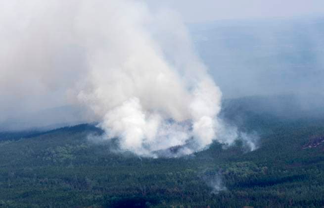 July 5, 2023, Lebel-sur-Quevillon, PQ, Canada: A smoke plume is seen rising from the forest south of Lebel-sur-Quevillon, Que., Wednesday, July 5, 2023. Lebel-sur-Quevillon Canada  - ZUMAc35_ 20230705_zaf_c35_062 Copyright: xAdrianxWyldx