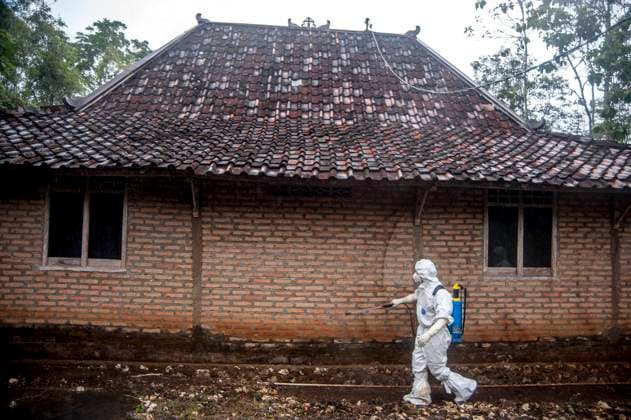 (230707) -- YOGYAKARTA, July 7, 2023 -- A staff member wearing protective suits sprays disinfectant to a house at Candirejo village in Gunung Kidul district, Yogyakarta, Indonesia, on July 7, 2023. One person has been confirmed dead from anthrax and 85 others have found to be infected after all of them consumed infected meat in Indonesia s Yogyakarta province, said local authorities on Tuesday. (Photo by Xinhua) INDONESIA-YOGYAKARTA-ANTHRAX AgungxSupriyanto 