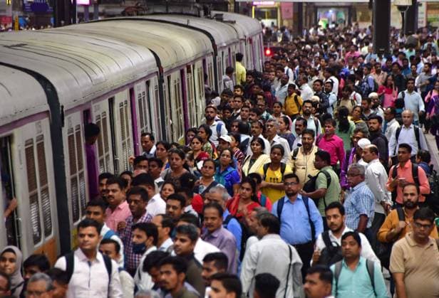 MUMBAI, INDIA - JULY 11: Commuters wait on a platform to board a local train, on World Population Day 2023, at CSMT, on July 11, 2023 in Mumbai, India. World Population Day is an annual event, observed on July 11 every year, which seeks to raise awareness of global population issues. The event was established by the Governing Council of the United Nations Development Programme in 1989. (Photo by Bhushan Koyande Hindustan Times ) World Population Day 2023