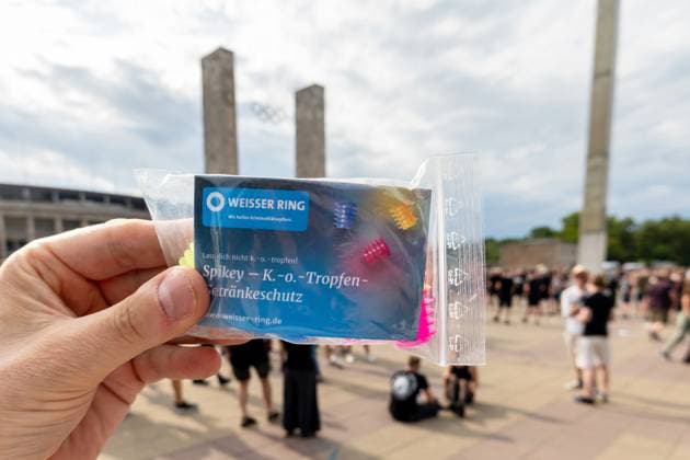 15 07 2023,Berlin,Concert of the band Rammstein in the evening in the Olympiastadion Impressions before the start outside the stadium The Berlin police distributes on site Spikey K O drops drink protection An action of the Weisser Ring