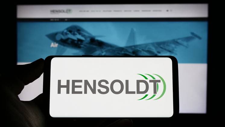 Person holding cellphone with logo of German defense company Hensoldt AG on screen. Stuttgart, Germany - 04-21-2023: Person holding cellphone with logo of German defense company Hensoldt AG on screen in front of business webpage. Focus on phone display. Copyright: xZoonar.com TimonxSchneiderx 20183740
