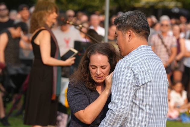 July 17, 2023, TORONTO, ON, CAN: Marie Aragona, a friend of Karolina Huebner-Makurat, is comforted after speaking at a public vigil, in Toronto, Monday, July 17, 2023. Huebner-Makurat, a mother of two was killed by a stray bullet on July 7 after a shooting in her Leslieville neighbourhood. TORONTO CAN  - ZUMAc35_ 20230717_zaf_c35_093 Copyright: xChrisxYoungx