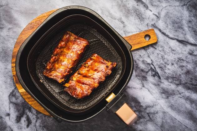 Modern cooking - preparing juicy spare ribs with honey sauce in airfryier Modern cooking - preparing juicy spare ribs with honey sauce in airfryier, BBQ meat Copyright: xZoonar.com IngridxBalabanovax 20351337