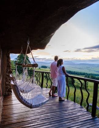 Couple of men and women on the terrace of a Lodge in the mountains, A couple of men and women on the terrace of a Lodge in the mountains, Drakensberg Mountain, Central Drakensberg Kwazulu Natal, view over green mountains in South Africa ,model released, Symbolfoto Copyright: xZoonar.com FokkexBaarssenx 20352413 ,model released, Symbolfoto ,property released