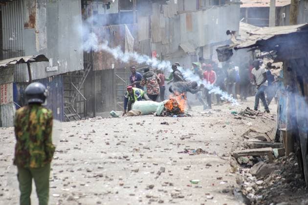 July 19, 2023, Nairobi, Kenya: A police officer looks on as protesters throw stones while chanting slogans during the demonstration called by Azimio Party leader Raila Odinga over high cost of living in Mathare Slums where two people were shot. Nairobi Kenya - ZUMAs197 20230719_zaa_s197_103 Copyright: xJohnxOchiengx