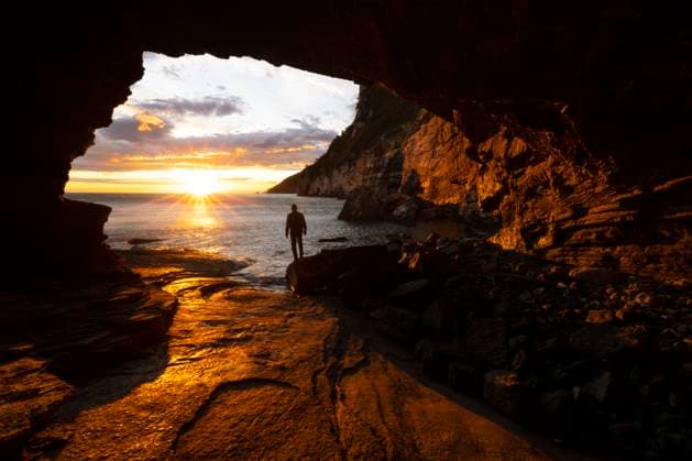 A boy admires a beautiful spring sunset from the Byron cave, Portovenere, La Spezia province, Liguria district, Italy, Europe Copyright: carloxalbertoxconti 1369-3