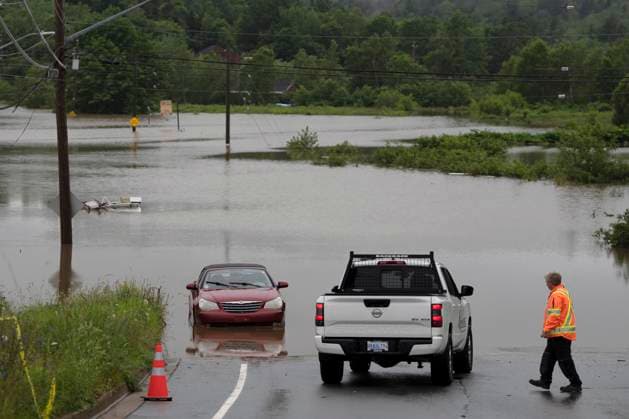 July 22, 2023, Halifax, NS, Canada: A man surveys damage at the edge of floodwater as vehicles are seen abandoned in water following a major rain event in Halifax on Saturday, July 22, 2023. Halifax Canada  - ZUMAc35_ 20230722_zaf_c35_026 Copyright: xDarrenxCalabresex