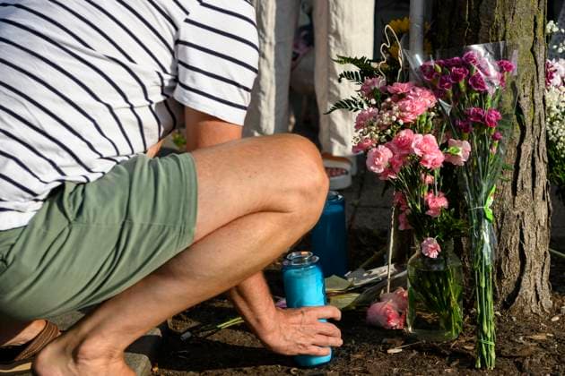 July 22, 2023, Toronto, ON, Canada: Friends and family members of Julianna Kozis and Reese Fallon, place candles and flowers during a gathering to mark five years since the attack on the city s Danforth Avenue, at Withrow Park in Toronto, Saturday July 22, 2023. Toronto Canada  - ZUMAc35_ 20230722_zaf_c35_083 Copyright: xChristopherxKatsarovx