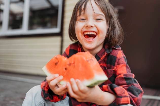 Creative Highlights Symbolbilder Cheerful boy holding fresh watermelon slice model released, Symbolfoto property released, ANAF01553
