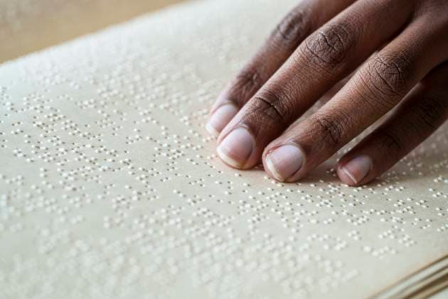 Woman reading braille text on page from book model released, Symbolfoto property released, AAZF00772