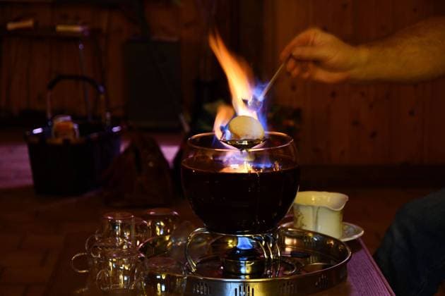Waiter putting a burning sugarloaf over a bowl of Feuerzangenbowle on a restaurant table Waiter putting a burning sugarloaf over a bowl of Feuerzangenbowle on a restaurant table Copyright: xZoonar.com RaffaelxHerrmannx 20506688