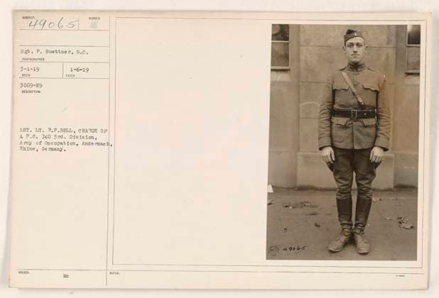 RECORD DATE NOT STATED 1st Lt. R.P. Bell standing in front of A.P.O. 730, 3rd Division, Army of Occupation, in Andernach, Rhine, Germany. Photograph taken on January 6, 1919. Responsibilities of Lt. Bell include overseeing the charge at A.P.O. 730. Sgt. P. Buettner, serving as the photographer, captured this image. Record received on March 1, 1919. Description issued with the number 49065. Note: Mention of 740 could be an error or additional information. Copyright: xpiemagsx 971_86704233 !ACHTUNG AUFNAHMEDATUM GESCHÄTZT!