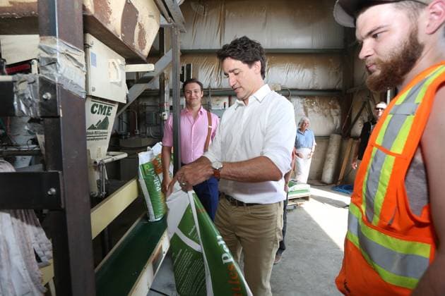 July 27, 2023, Summerford, NL, CANADA: Robin Phillpot, grandson of the owner of Cottles Island Lumber, left to right, Prime Minister Justin Trudeau and staff member Mitchell Jones during a visit to the facility in Summerford, Newfoundland and Labrador on Thursday, July 27, 2023. Summerford CANADA - ZUMAc35_ 20230727_zaf_c35_009 Copyright: xPaulxDalyx