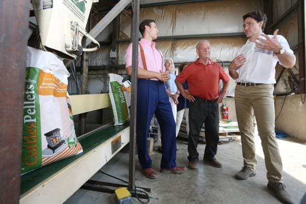 July 27, 2023, Summerford, NL, CANADA: Grandson Robin Phillpot, left to right, Rex Phillpot, owner of Cottles Island Lumber, meet with Prime Minister Justin Trudeau during a visit to the facility in Summerford, Newfoundland and Labrador on Thursday, July 27, 2023. Summerford CANADA - ZUMAc35_ 20230727_zaf_c35_011 Copyright: xPaulxDalyx