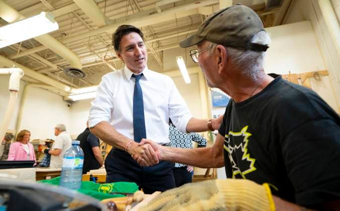 July 31, 2023, Hamilton, Ont, CAN: Prime Minister Justin Trudeau chats with Bob McLaughlin, 72, about his wood working project during a visit to Sackville Hill Senior Recreation Centre in Hamilton, Ont., Monday, July 31, 2023. Hamilton CAN - ZUMAc35_ 20230731_zaf_c35_072 Copyright: xPeterxPowerx