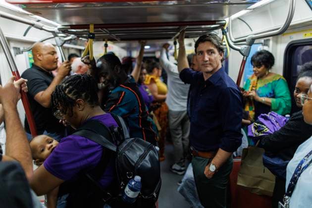 July 31, 2023, TORONTO, ON, CANADA: Shannon Victoria holds her 11-month-old daughter Shiloh as she stands by Canadian Prime Minister Justin Trudeau on a TTC train in Toronto, during the Underground Freedom Train Ride in Toronto, an event commemorating the abolition of slavery in the British Empire, Monday, July 31, 2023. TORONTO CANADA  - ZUMAc35_ 20230731_zaf_c35_109 Copyright: xColexBurstonx