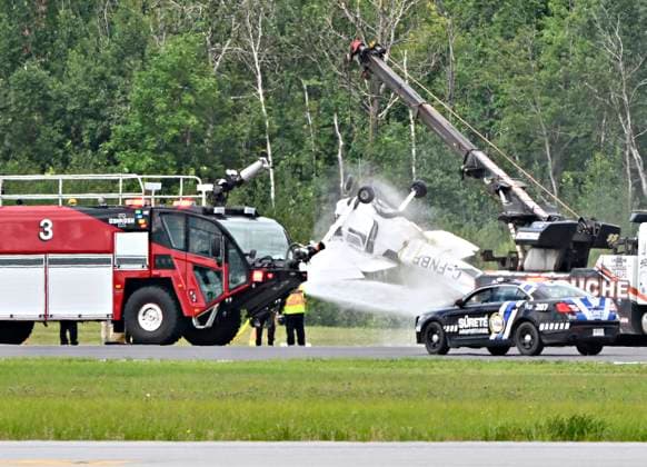August 1, 2023, QUEBEC, PQ, Canada: Firefighters spray down a Cessna 152 aircraft as it is towed away after it crashed on landing at the Jean-Lesage Airport in Quebec City, Tuesday, Aug. 1, 2023. One person was reported injured. QUEBEC Canada  - ZUMAc35_ 20230801_zaf_c35_022 Copyright: xJacquesxBoissinotx