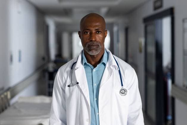 Portrait of african american male doctor wearing lab coat in corridor at hospital Portrait of african american male doctor wearing lab coat in corridor at hospital. Hospital, medicine, healthcare and work, unaltered., model released, , property released, Cape Town, South Africa, 2023-05-19T22:00:00.000Z, 4139253.jpg, people,portrait,african american,male doctor,wearing,lab coat,corridor,hospital,medicine,healthcare,work,unaltered,medical,doctor,clinic,care,health,treatment,patient,illness,disease,professional,nurse,person,virus,stethoscope,young,laboratory,adult,face,equipment,specialist,african,american,male,lab,coat Mature Adult,Woman,Female,Black
