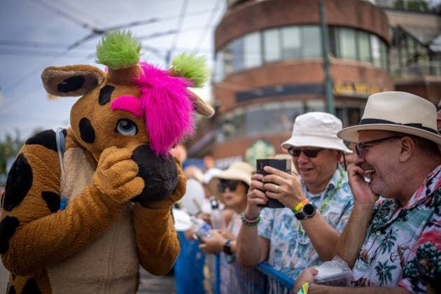 August 6, 2023, VANCOUVER, BC, CANADA: A person wearing a mascot suit, commonly referred to as a furry , giggles with a man in the crowd during the Pride Parade at English Bay in Vancouver, B.C., Sunday, Aug. 6, 2023. VANCOUVER CANADA - ZUMAc35_ 20230806_zaf_c35_014 Copyright: xEthanxCairnsx