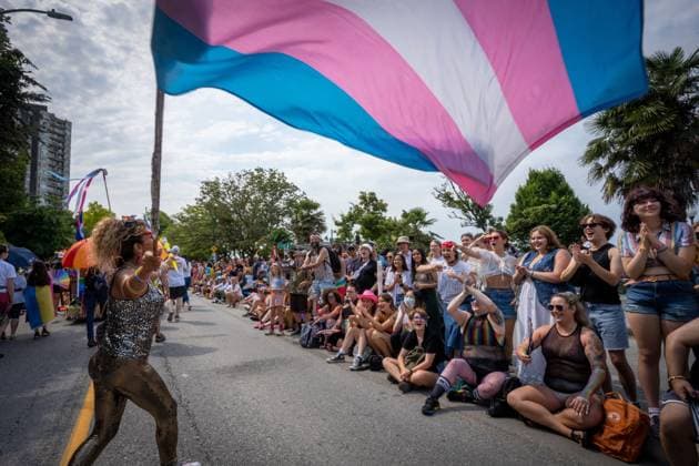 August 6, 2023, VANCOUVER, BC, CANADA: A person waves a trans pride flag during the Pride Parade at English Bay in Vancouver, B.C., Sunday, Aug. 6, 2023. VANCOUVER CANADA  - ZUMAc35_ 20230806_zaf_c35_013 Copyright: xEthanxCairnsx