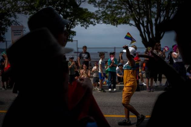 August 6, 2023, VANCOUVER, BC, CANADA: A boy waves a flag at people in the crowd during the Pride Parade at English Bay in Vancouver, B.C., Sunday, Aug. 6, 2023. VANCOUVER CANADA  - ZUMAc35_ 20230806_zaf_c35_015 Copyright: xEthanxCairnsx
