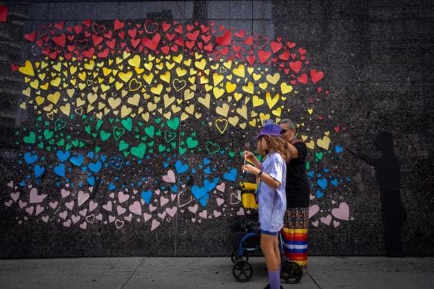 August 6, 2023, VANCOUVER, BC, CANADA: People pass a decorated wall during the Pride Parade at English Bay in Vancouver, B.C., Sunday, Aug. 6, 2023. VANCOUVER CANADA  - ZUMAc35_ 20230806_zaf_c35_019 Copyright: xEthanxCairnsx