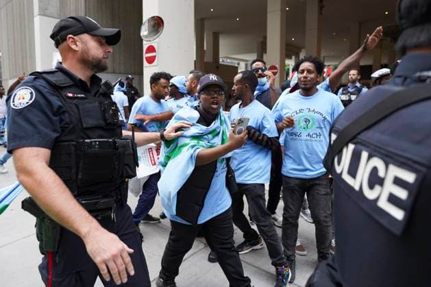 August 6, 2023, Toronto, ON, Canada: Toronto Police work the scene of a protest outside of the Sheraton Hotel in downtown Toronto, on Sunday, August 6 2023. The city of Toronto revoked the permit for an Eritrean cultural festival scheduled to run through the August long weekend after a number of violent clashes between participants and protesters sent nine people to hospital and stalled local traffic for hours. Toronto Canada  - ZUMAc35_ 20230806_zaf_c35_045 Copyright: xArlynxMcadoreyx