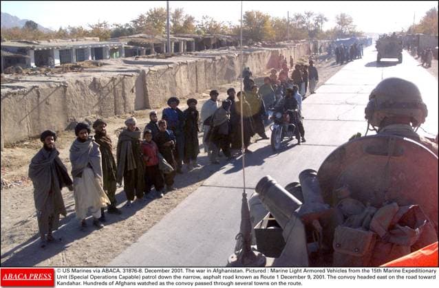 31876 08 US Marines via ABACA. 31876-8. December 2001. The war in Afghanistan. Pictured : Marine Light Armored Vehicles from the 15th Marine Expeditionary Unit (Special Operations Capable) patrol down the narrow, asphalt road known as Route 1 December 9, 2001. The convoy headed east on the road toward Kandahar. Hundreds of Afghans watched as the convoy passed through several towns on the route.  Copyright: xABACAx 31876_08 ABACAx 31876_08