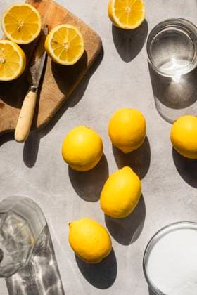 Lemons in hard light, with sugar, water and sliced lemons surrounding. Lemons in hard light, with sugar, water and sliced lemons surrounding. Copyright: xJoxBryantx JBR270423-3