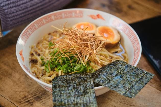 From above closeup of yummy ceramic bowl with ramen soup served on wooden table Model Released PhilippeDegroote_ID14566_439658_011 Copyright: xPhilippexDegrootex