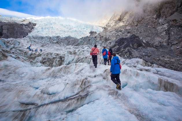 Franz Josef, New Zealand. Travelers exploring Franz Josef Glacier. Blue Ice, deep crevasses, caves and tunnels mark the ever changing ice. (MR)  Copyright: xMicahxWrightx x AU03 MWR0125