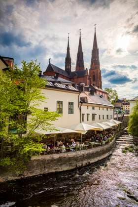 Sweden, Central Sweden, Uppsala, Domkyrka Cathedral with riverfront cafe  Copyright: xWalterxBibikowx x EU28 WBI0583