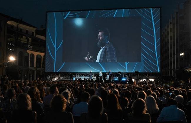 Locarno Film Festival, Preisträger Locarno, Swiss Locarno Film Festival 2023 red carpet Locarno,Swiss Locarno Film Festival 2023 Red carpet photocall Award 2023 photocall Golden Leopard 2023 best film Mantagheye bohrani (Critical Zone) by Ali Ahmadzadeh during the closing evening of the festival on the red carpet with winners of the various sections and the Iranian actress Zar Amir Ebrahimi In the photo: Sina Ataeian Dena producer raises the Pardo 2023 in Piazza Grande Locarno Swiss -  Copyright: xIPA ABACAx BRIPA20230812_260 IPA ABACAx BRIPA20230812_260