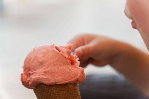 unrecognizable child eating strawberry ice cream with a spoon *** unkenntlich Kind essender Erdbeere Eis Creme mit einer löffeln 20676267 RECORD DATE NOT STATED