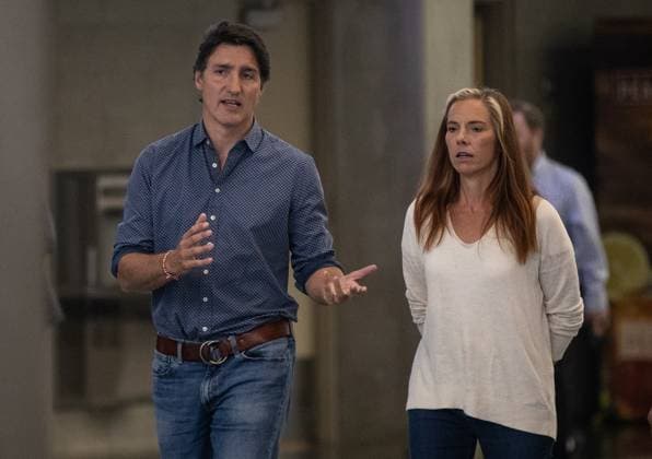August 18, 2023, EDMONTON, AB, CANADA: Prime Minister Justin Trudeau and Minister Caroline Wawzonek walk to a press conference to speaks on the wildfires in B.C. and the Northwest Territories after visiting evacuees in Edmonton, Friday, Aug. 18, 2023. EDMONTON CANADA  - ZUMAc35_ 20230818_zaf_c35_066 Copyright: xJasonxFransonx