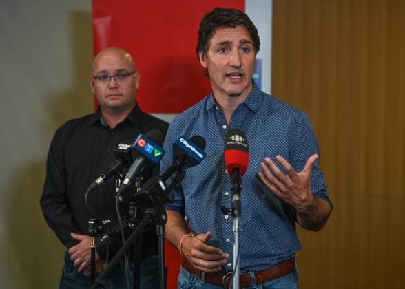 PM Trudeau Visits Wildfire Evacuees In Edmonton EDMONTON, CANADA - AUGUST 18, 2023: Canadian PM Justin Trudeau speaks at Edmonton s Expo Center transformed into the Emergency Response Center in Edmonton, on August 18, 2023, in Edmonton s Expo Center, Edmonton, Canada. PM Trudeau visited wildfire evacuees from the Northwest Territories. The Edmonton hub helped 974 residents and 60 animals by providing essentials. PM Trudeau highlighted community resilience amid home concerns and thanked Canadians for unprecedented summer support during fires and floods, highlighting responsive and compassionate individuals, while pledging federal coordination with British Columbia wildfires. Edmonton Canada  Copyright: xArturxWidakx originalFilename: widak-pmtrudea230818_npmoB.jpg