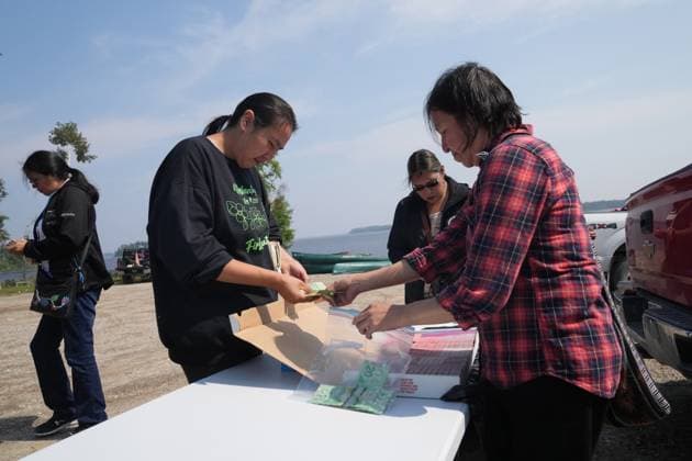 August 18, 2023, NESKANTAGA, ON, CAN: People line up to buy bing balls during the Neskantaga First Nation Summer Festival, in Neskantaga, Ont., Friday, Aug. 18, 2023. NESKANTAGA CAN  - ZUMAc35_ 20230818_zaf_c35_091 Copyright: xChrisxYoungx