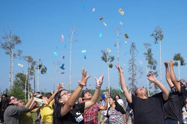 August 18, 2023, NESKANTAGA, ON, CAN: People reach to catch bing balls tossed into the crowd, during the Neskantaga First Nation Summer Festival, in Neskantaga, Ont., Friday, Aug. 18, 2023. NESKANTAGA CAN - ZUMAc35_ 20230818_zaf_c35_096 Copyright: xChrisxYoungx