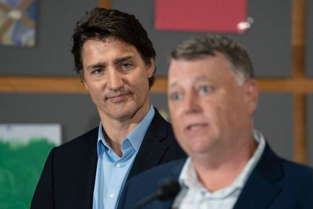 August 21, 2023, Cornwall, PEI, Canada: Prime Minister Justin Trudeau, left, looks on as Dennis King, Premier of Prince Edward Island, speaks to reporters at the Island Montessori Academy in Cornwall, P.E.I., Monday, Aug. 21, 2023. Cornwall Canada - ZUMAc35_ 20230821_zaf_c35_034 Copyright: xDarrenxCalabresex