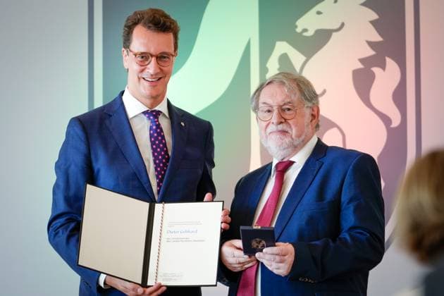 Award of the Order of Merit of the State of North Rhine Westphalia Dieter Gebhard from Gelsenkirchen the Chairman of the Youth Welfare Committee in the Council of the City of Gelsenkirchen with Hendrik Wuest Prime Minister of North Rhine Westphalia with the Cross of Merit and the certificate at the