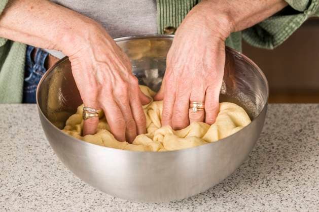 Woman punching down Monkey Bread dough, prior to forming it into balls. (MR)  Copyright: xJanetxHortonx x LI11 JHO0013
