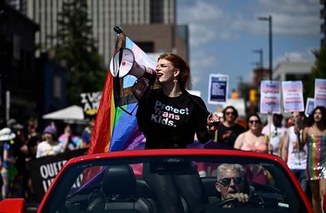 August 27, 2023, Ottawa, ON, CAN: Parade grand marshal Fae Johnstone calls out chants through a megaphone during the Capital Pride Parade in Ottawa, on Sunday, Aug. 27, 2023. Ottawa CAN  - ZUMAc35_ 20230827_zaf_c35_025 Copyright: xJustinxTangx