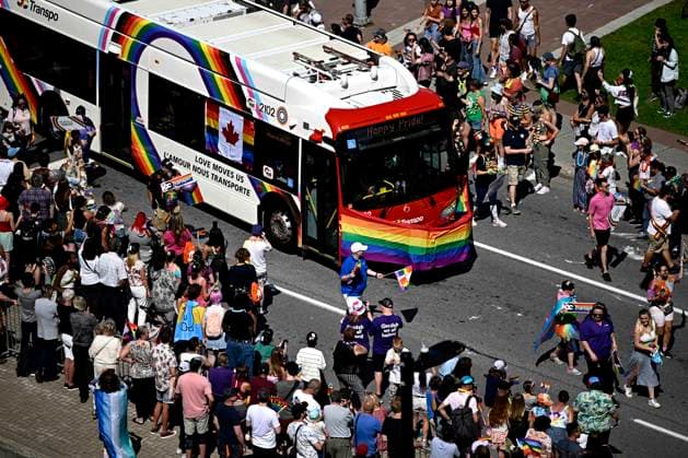 August 27, 2023, Ottawa, ON, CAN: People watch an OC Transpo bus make its way along the parade route during the Capital Pride Parade in Ottawa, on Sunday, Aug. 27, 2023. Ottawa CAN  - ZUMAc35_ 20230827_zaf_c35_037 Copyright: xJustinxTangx