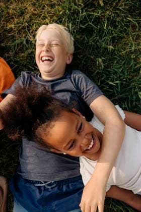 Directly above shot of happy male and female friends laughing while lying on grass at summer camp Sweden, Stockholm, model released Copyright: xMaskotx , MA103408 MA103408