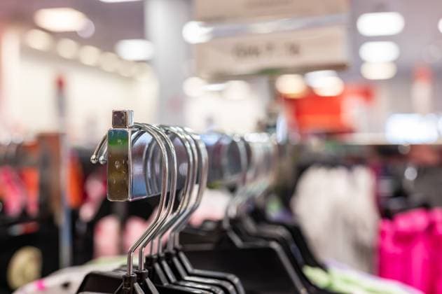 Row of coat hangers on a retail store shelf. Row of coat hangers on a retail store shelf. . High quality photo Copyright: xZoonar.com STEVENxWHITEx 19539487